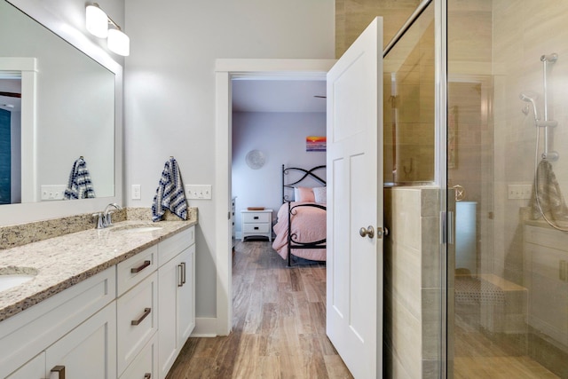 bathroom featuring a shower with door, vanity, and hardwood / wood-style floors