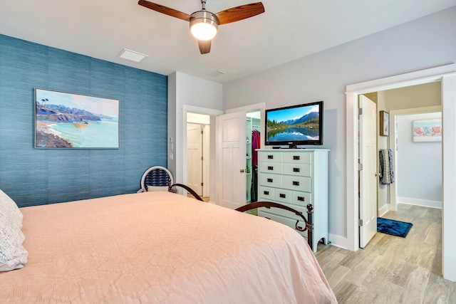 bedroom with ceiling fan and light wood-type flooring