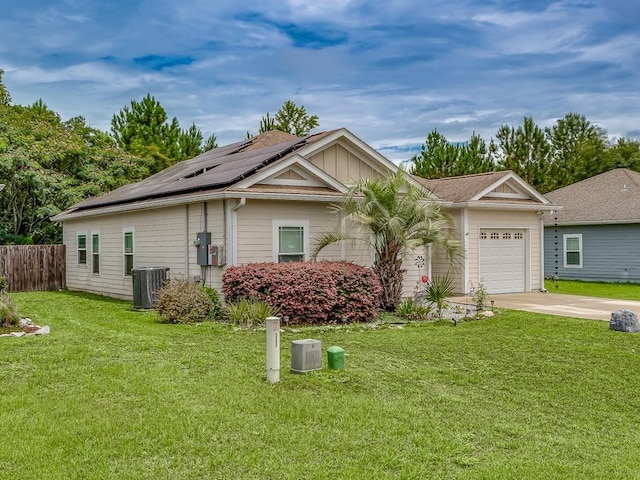 single story home featuring a garage, central AC, a front yard, and solar panels