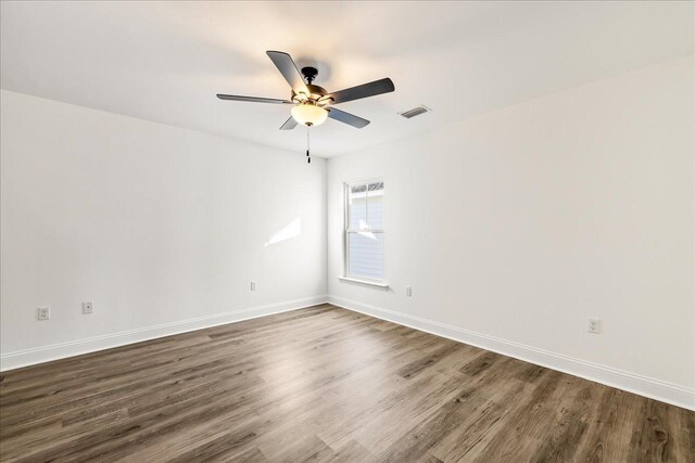 unfurnished room with ceiling fan and dark hardwood / wood-style floors