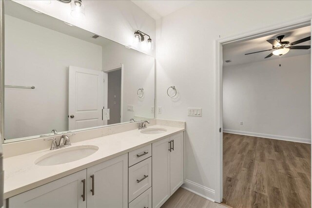 bathroom with hardwood / wood-style floors, vanity, and ceiling fan