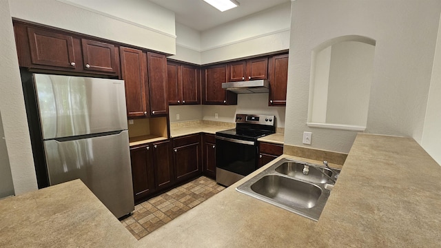 2801 Chancellorsville Dr Unit 1316, Tallahassee, FL 32312 - kitchen featuring stainless steel appliances, a sink, under cabinet range hood, light countertops, and dark brown cabinets