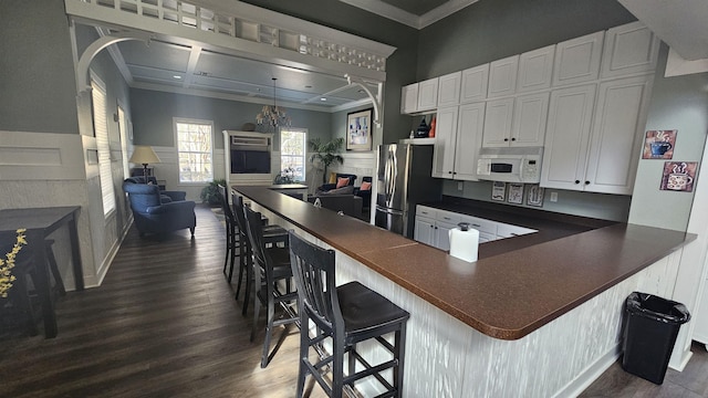 2801 Chancellorsville Dr Unit 1316, Tallahassee, FL 32312 - kitchen featuring white microwave, stainless steel refrigerator with ice dispenser, dark countertops, dark wood-type flooring, and crown molding