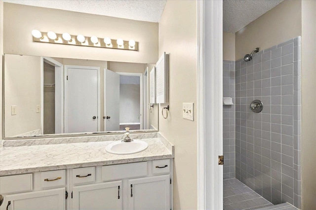 1538 Mclawrence Way, Tallahassee, FL 32317 - bathroom with a tile shower, vanity, and a textured ceiling