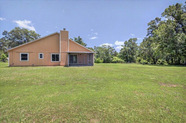 1538 Mclawrence Way, Tallahassee, FL 32317 - back of house with a lawn, a chimney, and a sunroom