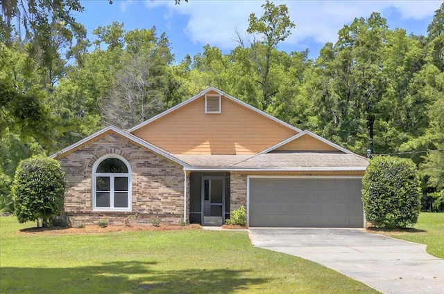 1538 Mclawrence Way, Tallahassee, FL 32317 - view of front of home featuring an attached garage, driveway, a front lawn, and brick siding