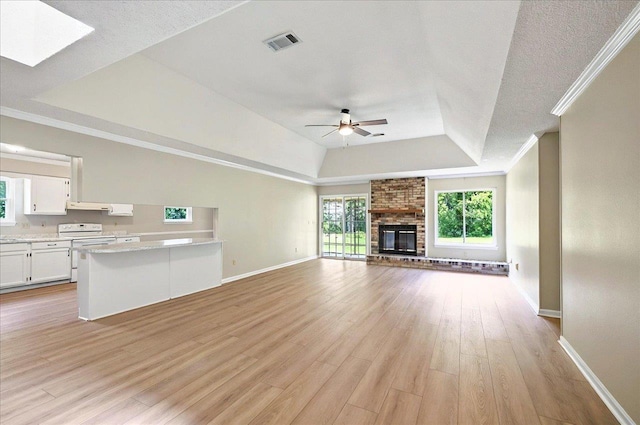 1538 Mclawrence Way, Tallahassee, FL 32317 - unfurnished living room featuring a raised ceiling, ceiling fan, baseboards, light wood-type flooring, and crown molding