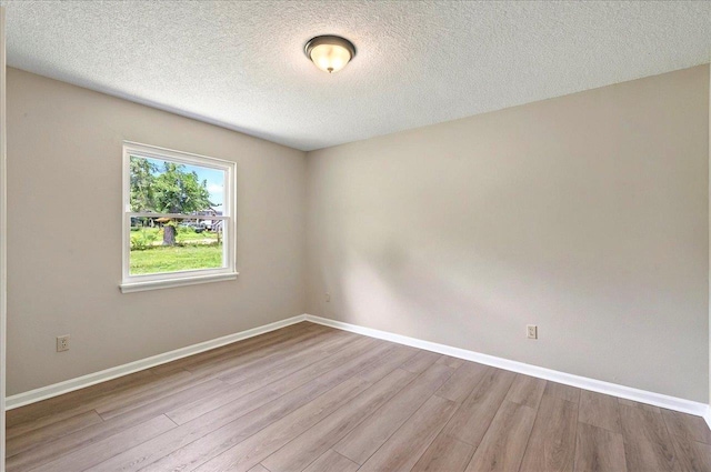 1538 Mclawrence Way, Tallahassee, FL 32317 - unfurnished room with wood finished floors, baseboards, and a textured ceiling