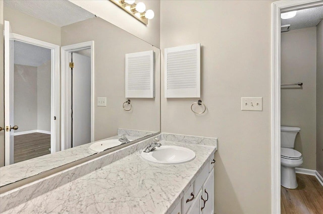 1538 Mclawrence Way, Tallahassee, FL 32317 - bathroom featuring vanity, wood finished floors, toilet, and baseboards