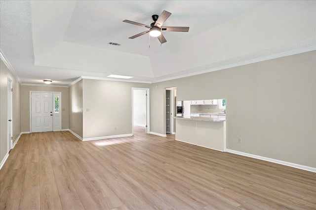 1538 Mclawrence Way, Tallahassee, FL 32317 - unfurnished living room featuring ceiling fan, ornamental molding, a raised ceiling, and light wood-type flooring