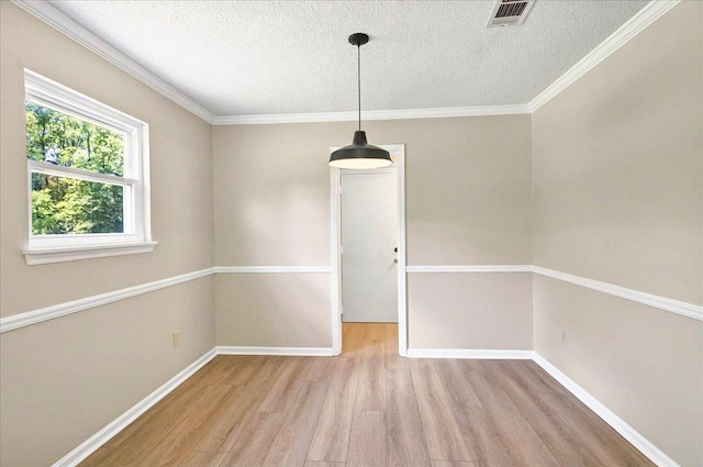 1538 Mclawrence Way, Tallahassee, FL 32317 - unfurnished dining area with wood finished floors, a textured ceiling, baseboards, and ornamental molding