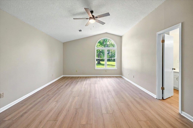 1538 Mclawrence Way, Tallahassee, FL 32317 - empty room with light wood-type flooring, vaulted ceiling, ceiling fan, a textured ceiling, and baseboards