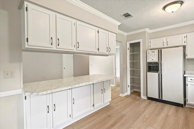 1538 Mclawrence Way, Tallahassee, FL 32317 - kitchen featuring white fridge with ice dispenser, light wood-style floors, white cabinetry, light countertops, and a textured ceiling