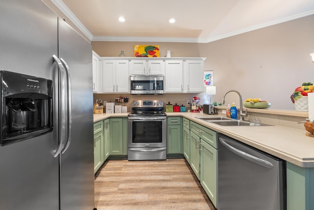 kitchen with appliances with stainless steel finishes, white cabinets, light countertops, and a peninsula