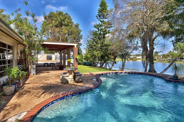 view of pool with a patio and a water view