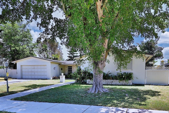 ranch-style home with a front yard and a garage