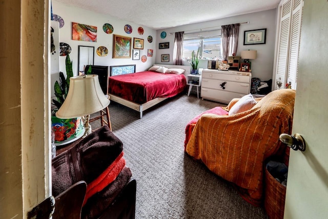 bedroom with dark colored carpet and a textured ceiling