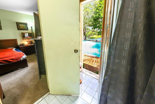 doorway to outside featuring light colored carpet and a textured ceiling