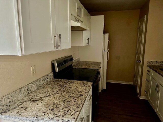 kitchen with stainless steel electric range, dark hardwood / wood-style flooring, white fridge, light stone countertops, and white cabinetry