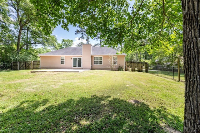 2304 Chester Ct, Tallahassee, FL 32312 - rear view of property featuring a yard, a patio area, a chimney, and a fenced backyard
