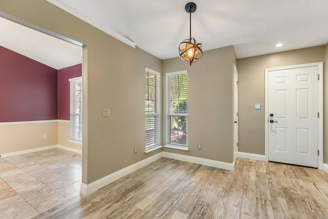 2304 Chester Ct, Tallahassee, FL 32312 - interior space with baseboards, wood finished floors, and an inviting chandelier