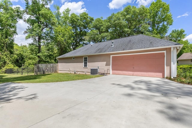 2304 Chester Ct, Tallahassee, FL 32312 - view of home's exterior featuring central AC unit, a shingled roof, fence, a yard, and a garage
