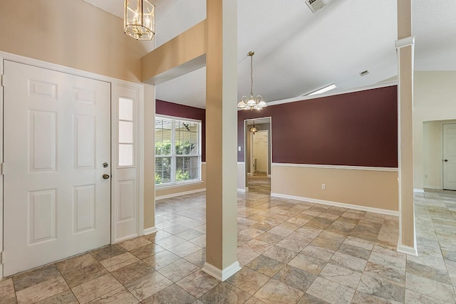 2304 Chester Ct, Tallahassee, FL 32312 - foyer with an inviting chandelier, stone tile floors, vaulted ceiling, and baseboards