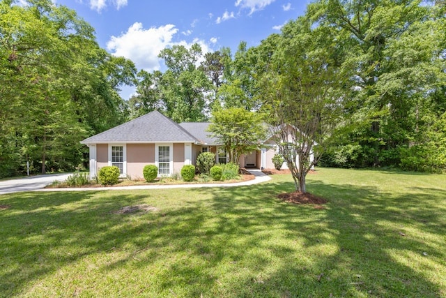 2304 Chester Ct, Tallahassee, FL 32312 - ranch-style home featuring roof with shingles, a front yard, and stucco siding