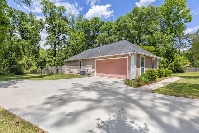 2304 Chester Ct, Tallahassee, FL 32312 - view of property exterior featuring fence, an attached garage, driveway, a lawn, and roof with shingles
