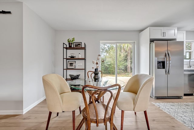 dining space with light wood-type flooring