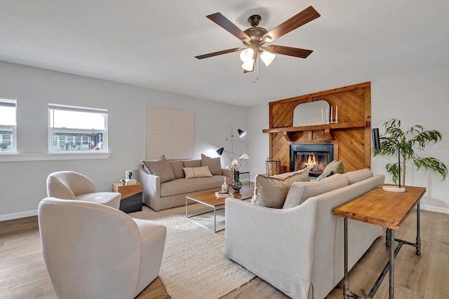 living room with light hardwood / wood-style floors and ceiling fan