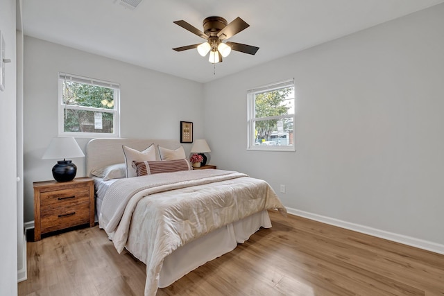 bedroom with light hardwood / wood-style flooring and ceiling fan