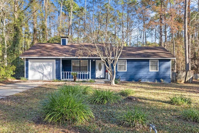 ranch-style house featuring covered porch and a garage