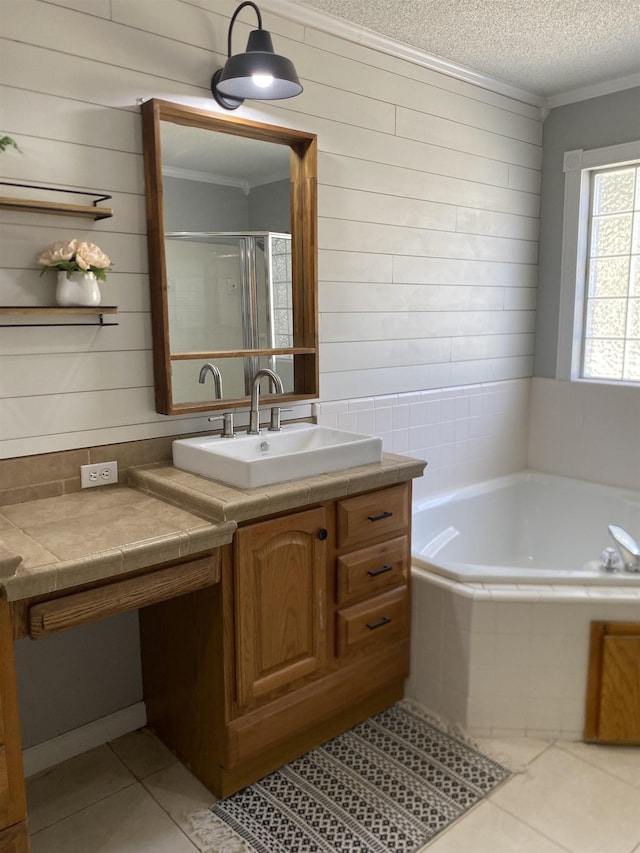 bathroom with crown molding, tile patterned flooring, vanity, plus walk in shower, and a textured ceiling