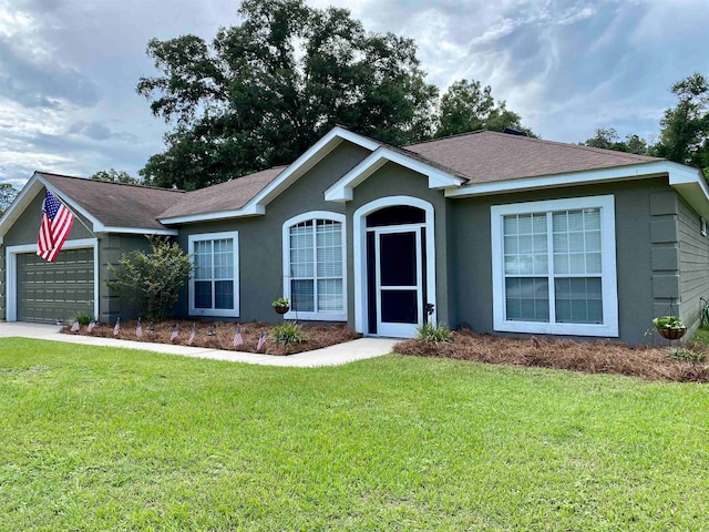 ranch-style house featuring a garage and a front yard