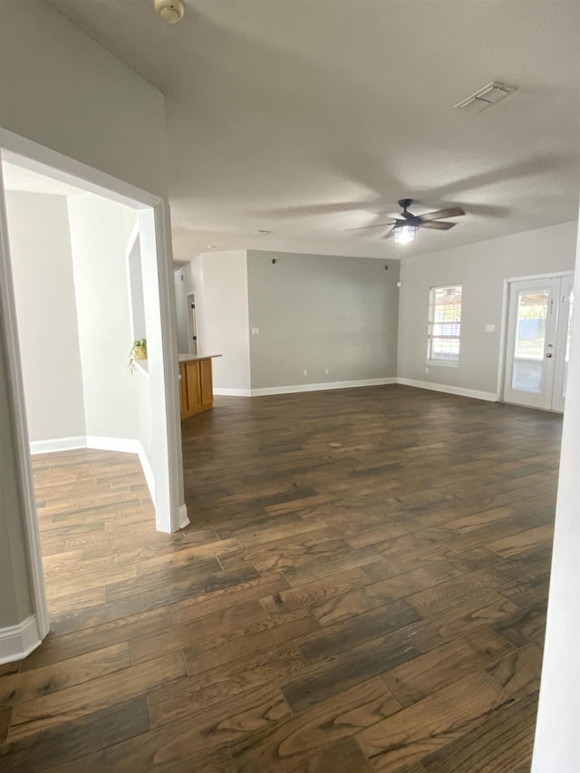 spare room featuring dark wood-type flooring and ceiling fan