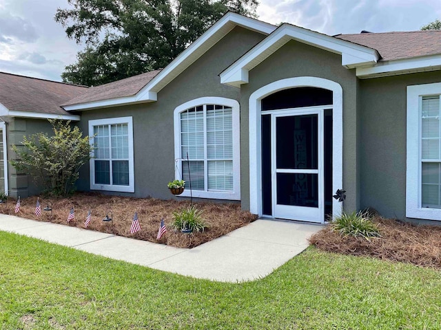 property entrance with a yard