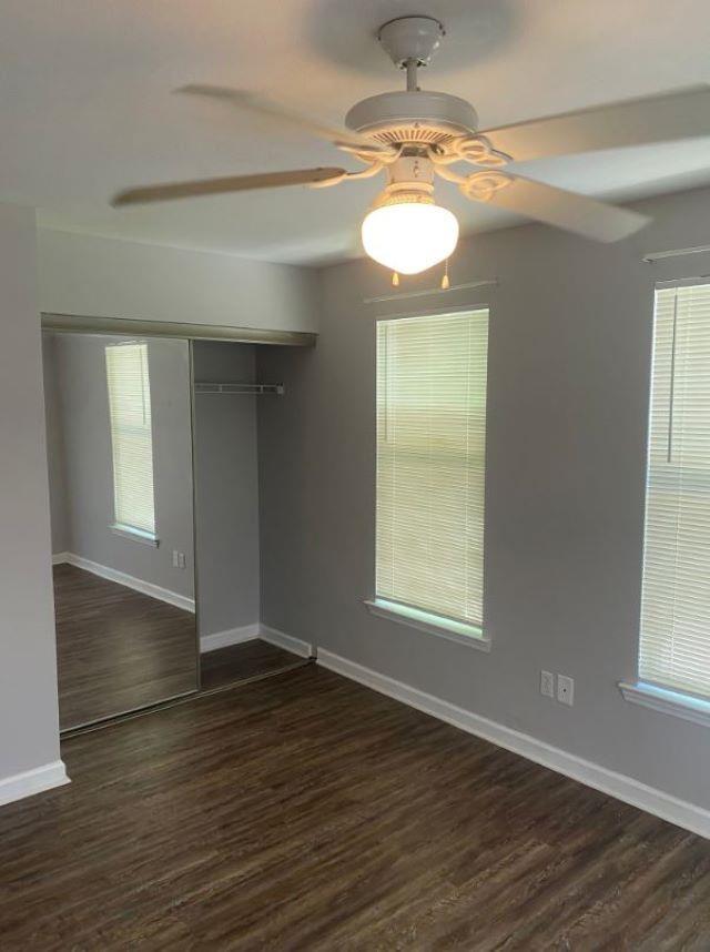 1417 Pullen Rd Unit 101, Tallahassee, FL 32303 - empty room featuring ceiling fan, dark wood-style floors, and healthy amount of natural light