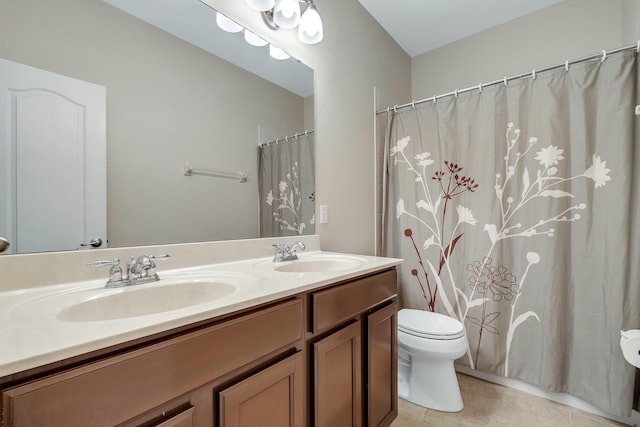 full bath featuring a sink, tile patterned flooring, toilet, and double vanity