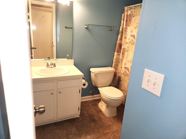 bathroom with vanity, tile patterned flooring, and toilet