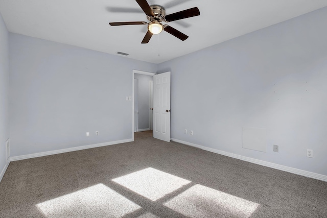 carpeted spare room with ceiling fan