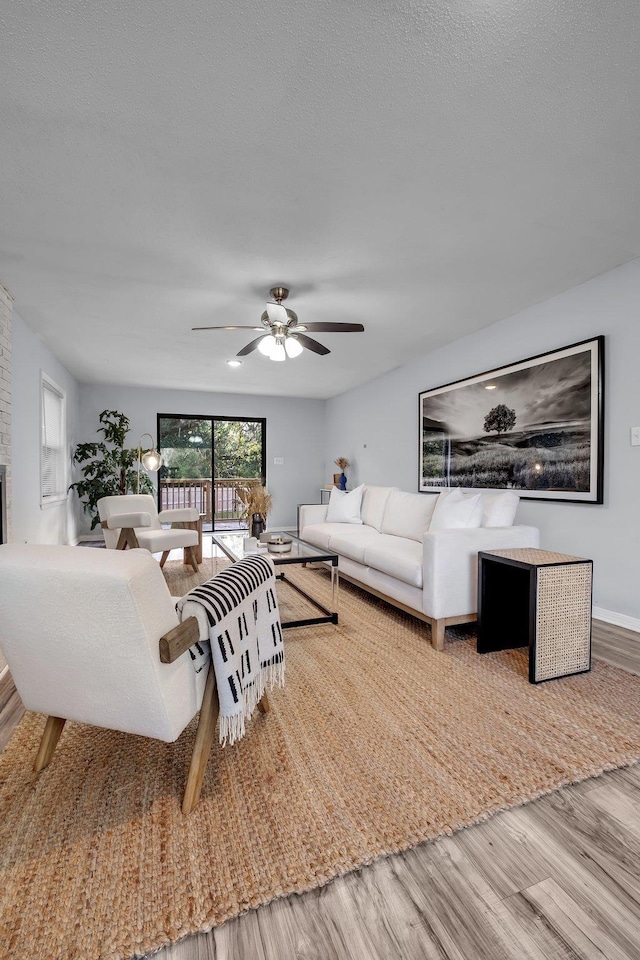 living room with ceiling fan and wood-type flooring