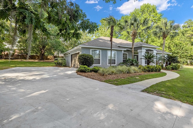 view of front of home with a front lawn and a garage