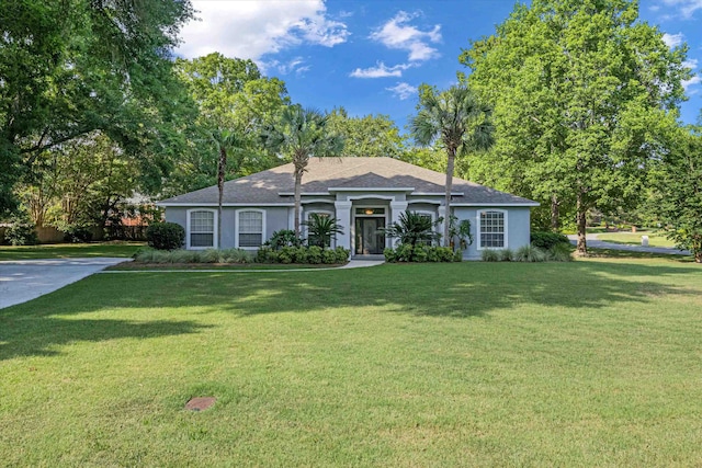 ranch-style home featuring a front yard