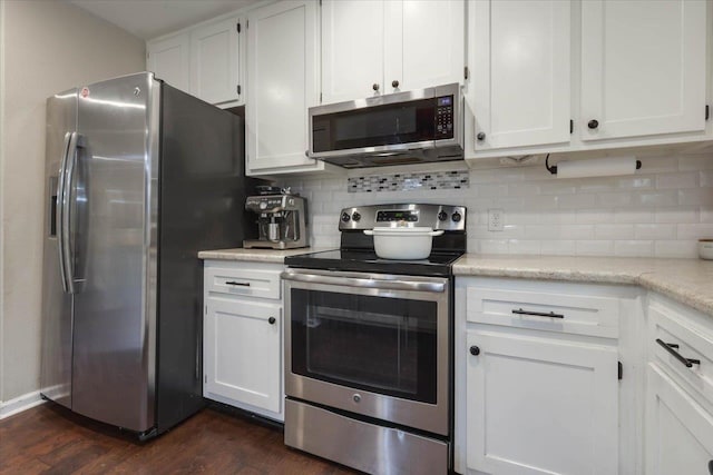 3256 N Shannon Lakes Dr, Tallahassee, FL 32309 - kitchen featuring appliances with stainless steel finishes, dark wood-style flooring, white cabinets, and backsplash