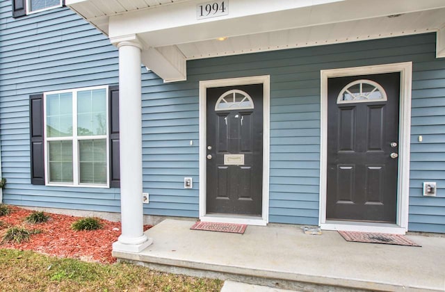 view of exterior entry with a porch