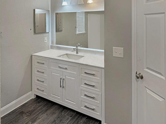 4434 Gearhart Rd Unit 1601, Tallahassee, FL 32303 - bathroom featuring vanity, wood finished floors, a textured wall, and baseboards