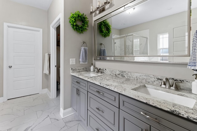10732 Sycamore Ridge Ln, Tallahassee, FL 32305 - full bathroom featuring a shower stall, double vanity, baseboards, and marble look tiles
