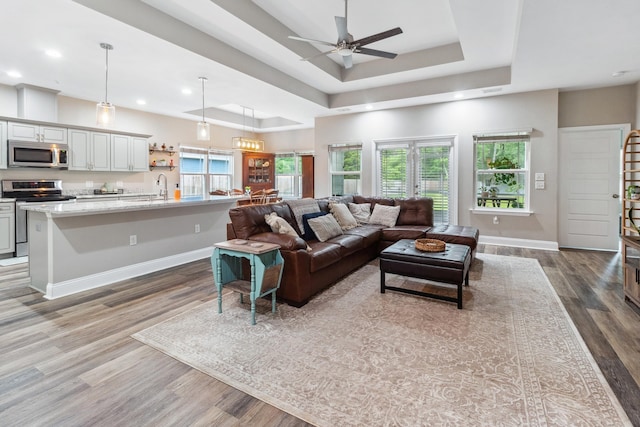 10732 Sycamore Ridge Ln, Tallahassee, FL 32305 - living room with a raised ceiling, wood finished floors, a ceiling fan, baseboards, and recessed lighting