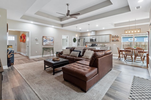 10732 Sycamore Ridge Ln, Tallahassee, FL 32305 - living area featuring a tray ceiling, a ceiling fan, baseboards, recessed lighting, and light wood-type flooring